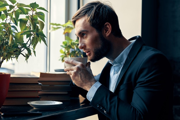 Hombre de negocios en un traje de café bebiendo café descansando desayuno foto de alta calidad