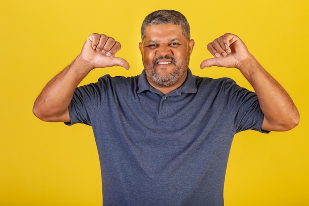 Hombre negro brasileño sonriendo adulto no le gusta el pulgar hacia abajo negativo