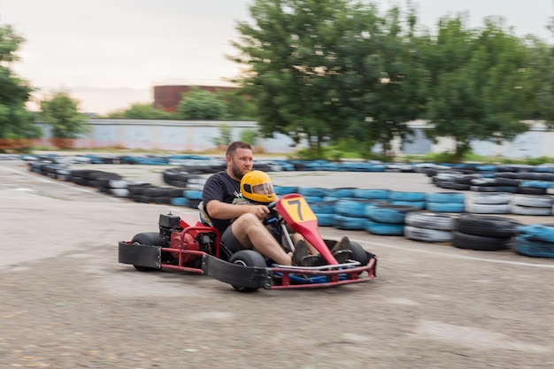 Hombre y niño juntos van al coche de carreras deportivo borroso en movimiento