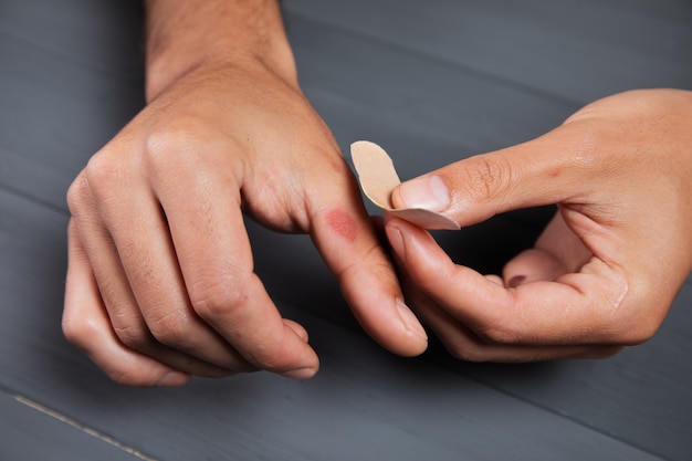 Un hombre pega un parche en el maíz de su mano