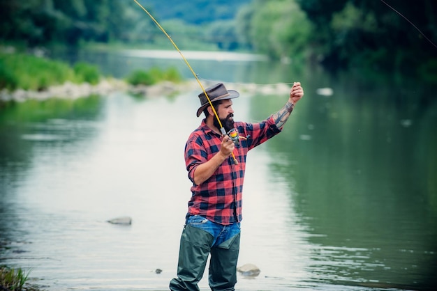 Hombre pescador en río o lago con caña de pescar