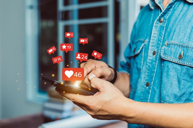 Foto hombre de pie en un teléfono móvil jugando a las redes sociales en la casa