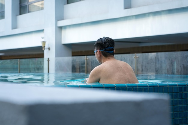 Hombre en la piscina en concepto de vacaciones