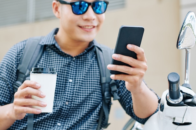 Hombre positivo leyendo mensajes de texto