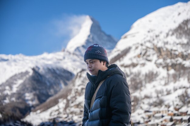 Hombre en el pueblo de Zermatt con la montaña Matterhorn en la mañana Zermatt Suiza