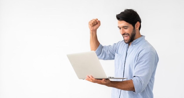 Hombre que sostiene la computadora portátil celebra el éxito