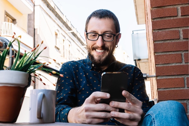 El hombre revisa el teléfono inteligente