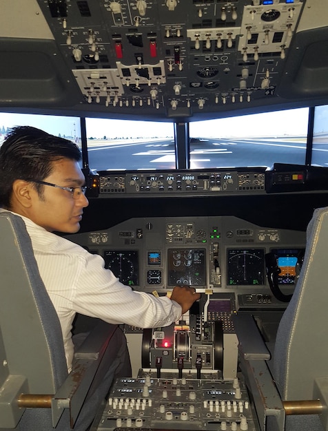 Foto hombre sentado en la cabina de un avión