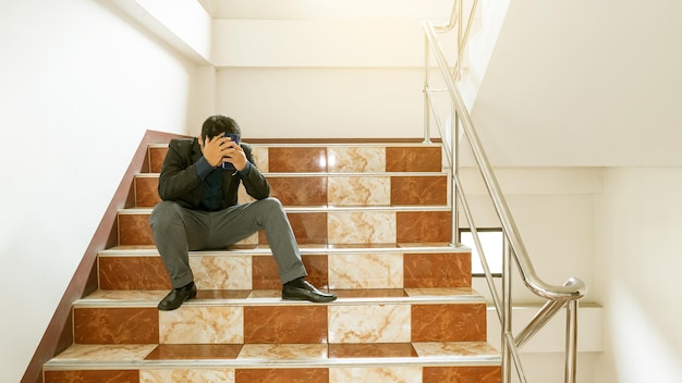 Foto hombre sentado en la escalera