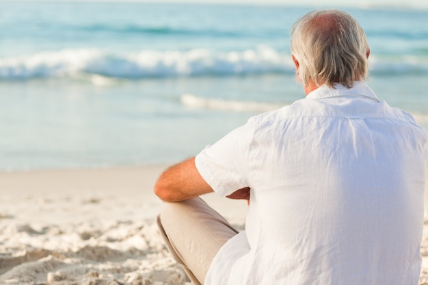 Hombre sentado en la playa