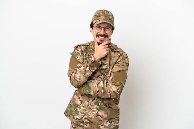 Hombre soldado aislado sobre fondo blanco con gafas y sonriendo