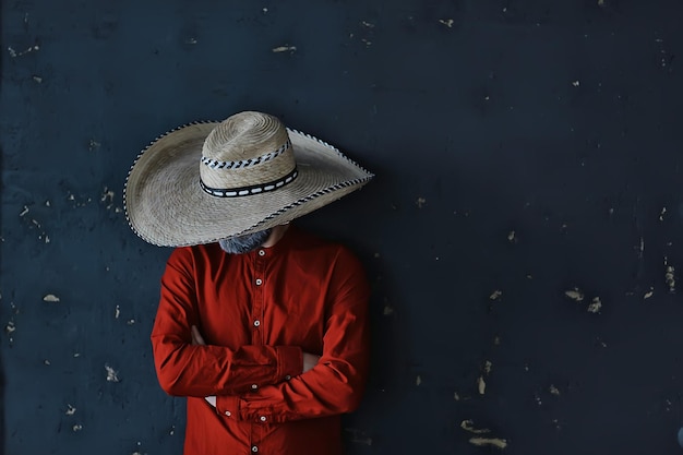 hombre en un sombrero con ala de paja, esconde su rostro, chico de incógnito, estilo de música country abstracto américa oeste