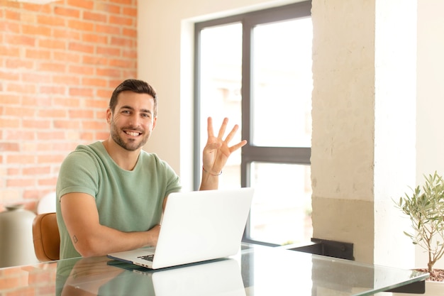 Hombre sonriendo y mirando amistosamente, mostrando el número cuatro o cuarto con la mano hacia adelante, contando hacia atrás