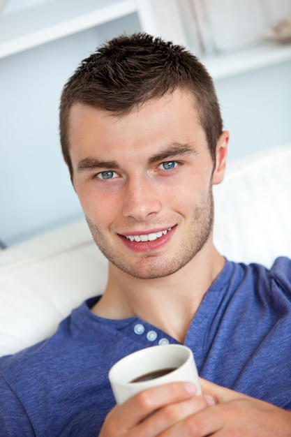 Hombre sonriente bebiendo un café