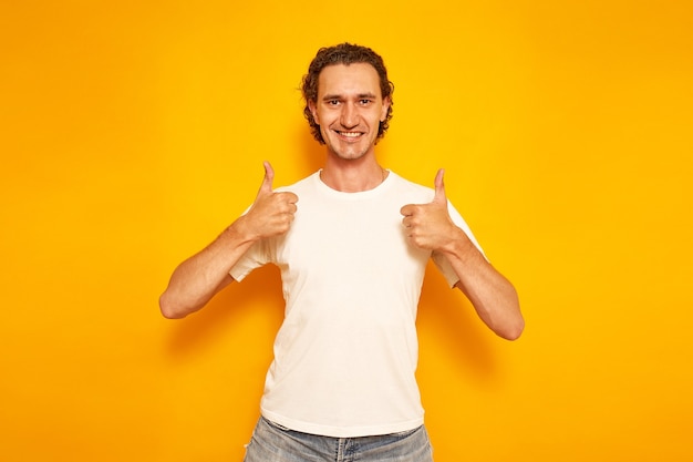 hombre sonriente en ropa casual da pulgar hacia arriba como señal de que todo está bien, pone me gusta espacio para texto