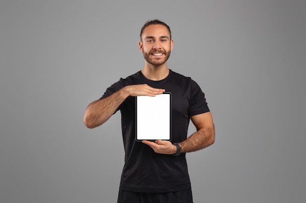 Hombre sosteniendo una tableta con pantalla en blanco