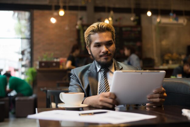Hombre sosteniendo una taza de café en un restaurante