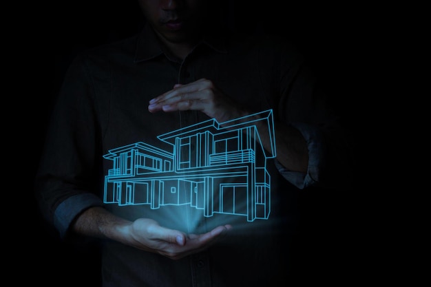 Un hombre sostiene una casa iluminada con un resplandor de neón en la oscuridad.