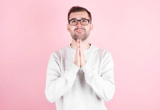 Hombre con un suéter blanco de casa pide un deseo por su cumpleaños.