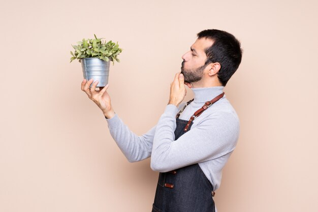 Hombre sujetando una planta sobre aislado