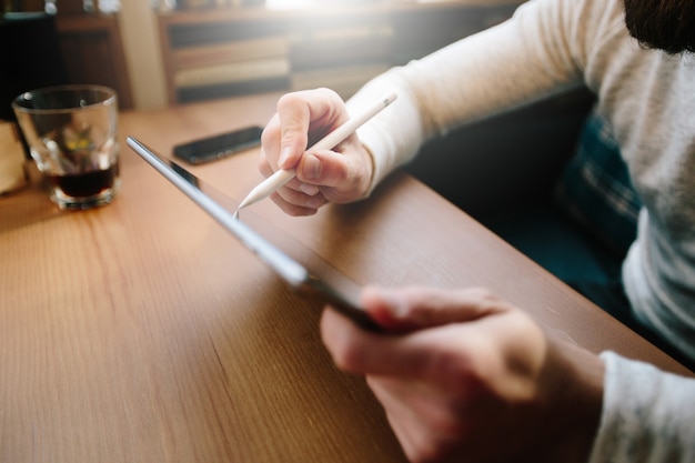 Hombre con tablet pc con un lápiz en un escritorio