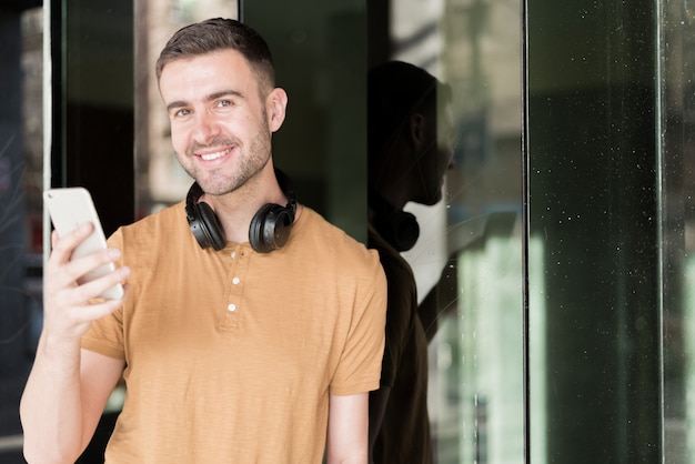 Hombre con teléfono móvil y auriculares