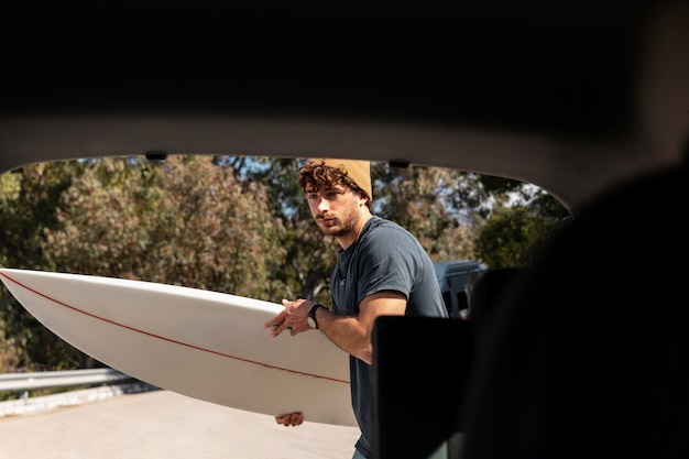 Foto hombre de tiro medio con tabla de surf