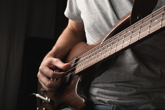 Hombre tocando solo de instrumento de bajo eléctrico de cuatro cuerdas