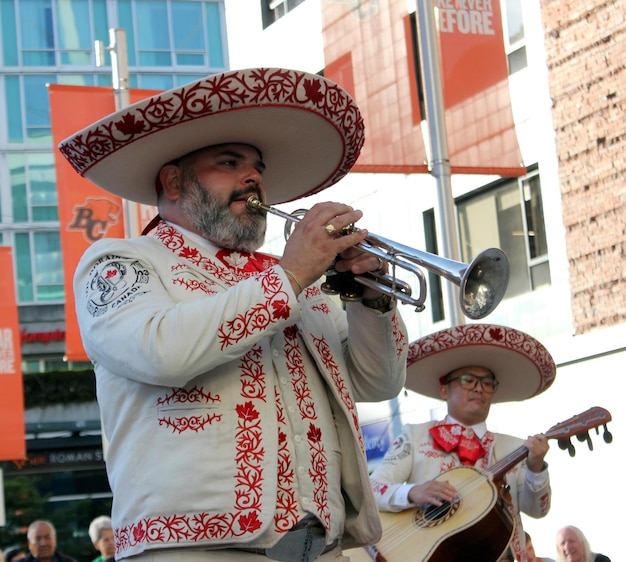 un hombre tocando un trombón frente a un letrero que dice pompei
