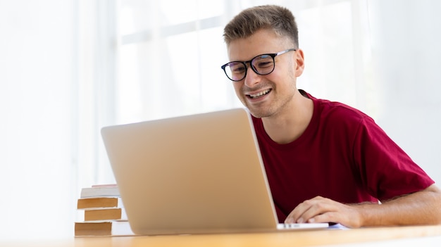 Hombre trabajando desde casa en la moderna sala blanca