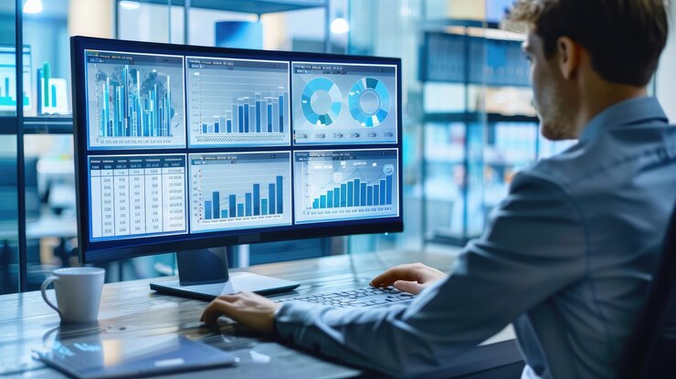 Foto un hombre trabajando en una computadora con un gráfico en la pantalla