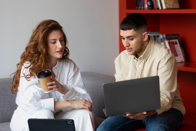 Hombre trans en el trabajo con laptop