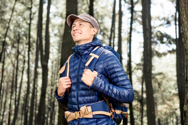 Hombre turístico asiático joven con viajar de la chaqueta azul