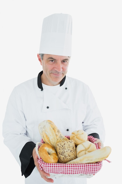 Hombre en uniforme de chef con cesta de pan