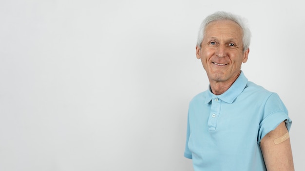 Foto hombre con vendaje en el brazo después de la inyección de la vacuna