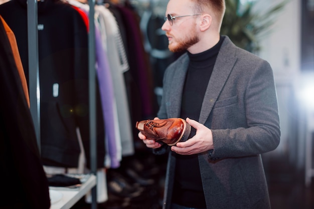 Foto hombre en una zapatería compra zapatos