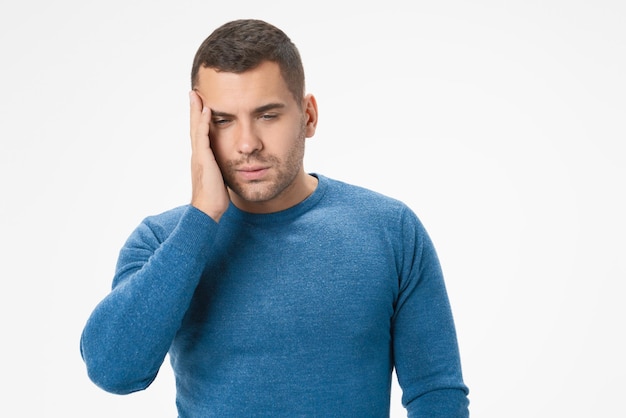 Los hombres caucásicos malsanos sufren de fuerte dolor de cabeza y están cansados aislados en el fondo del estudio blanco