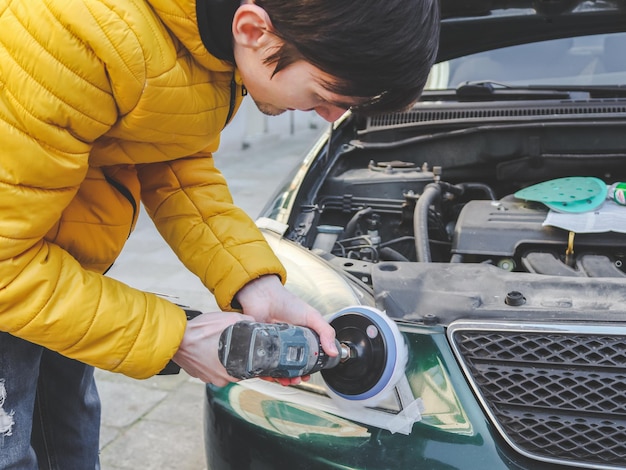 Los hombres morenos pulen los faros del coche