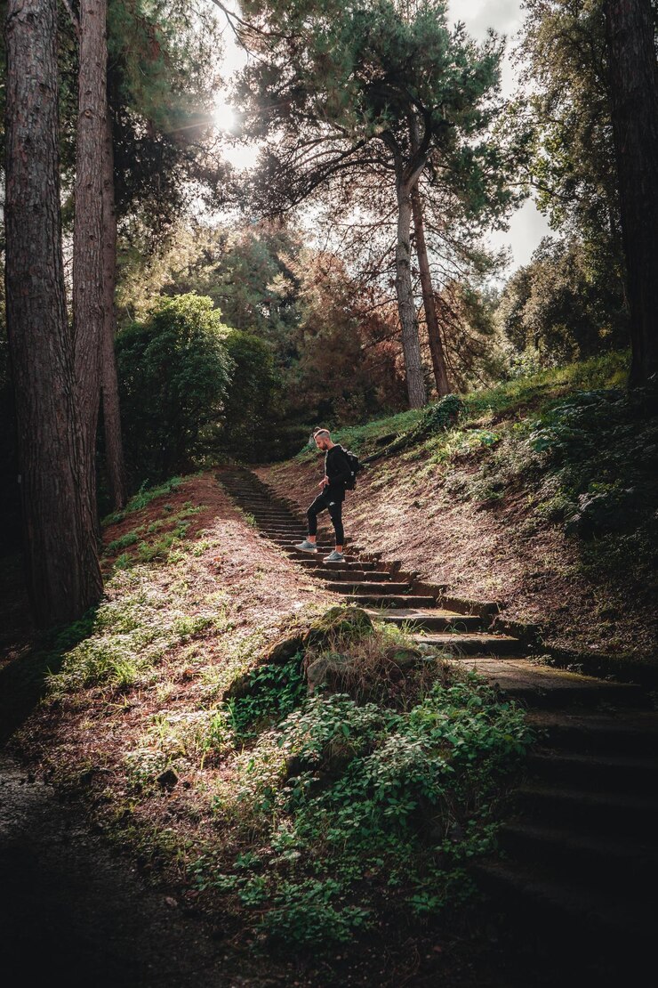 Foto homem adulto a subir escadas na floresta