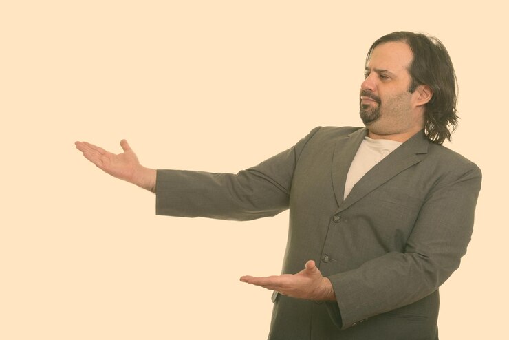 Foto homem adulto em pé contra um fundo cinzento