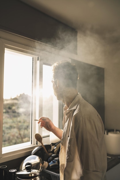 Homem adulto fumando cigarro RYO ou maconha em casa