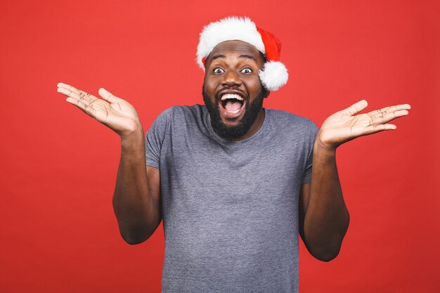 Homem afro-americano de camiseta cinza e chapéu de papai noel