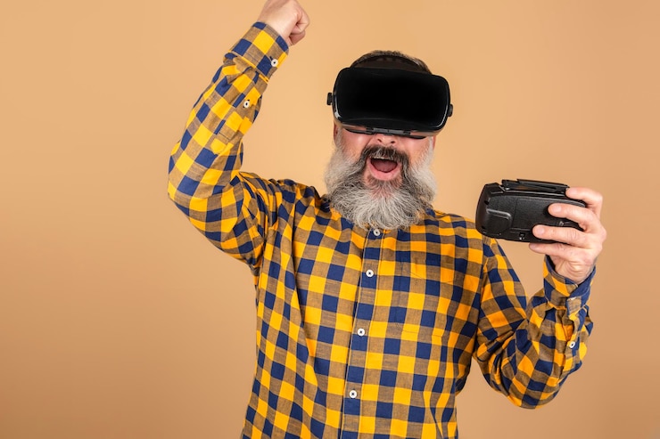 Foto homem alegre com óculos 3d brincando com um joystick em um fundo amarelo