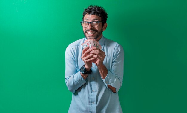 Homem amigável e feliz com dinheiro nas mãos olhando para a câmera Pessoa feliz com dinheiro nas mãos isolado Pessoa feliz com dinheiro nas mãos olhando para a câmera