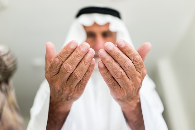 Homem árabe muçulmano idoso que reza