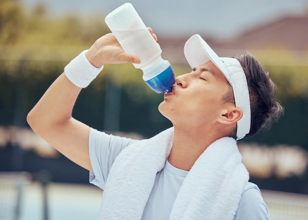 Homem asiático água potável fitness e relaxar após um treino ou exercício de sessão de treinamento Atleta de saúde e esportes masculino descansando com líquido refrescante depois de praticar um esporte cardio ou correr