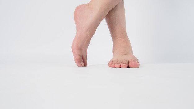 Homem asiático com os pés descalços é isolado no fundo branco.