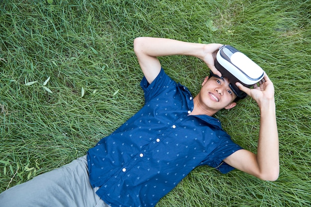Homem asiático usando o fone de ouvido de realidade virtual