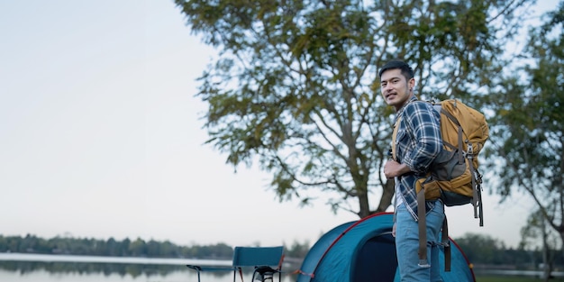 Homem asiático viajando com tenda acampando no topo da montanha ao ar livre estilo de vida de aventura caminhadas férias de verão ativas.