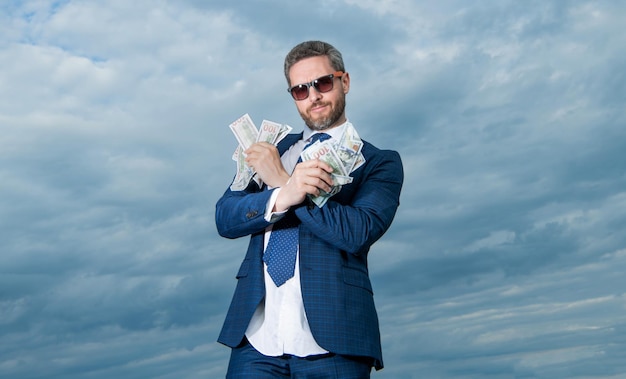 Homem bilionário alegre com dinheiro em foto de terno de homem bilionário com dinheiro